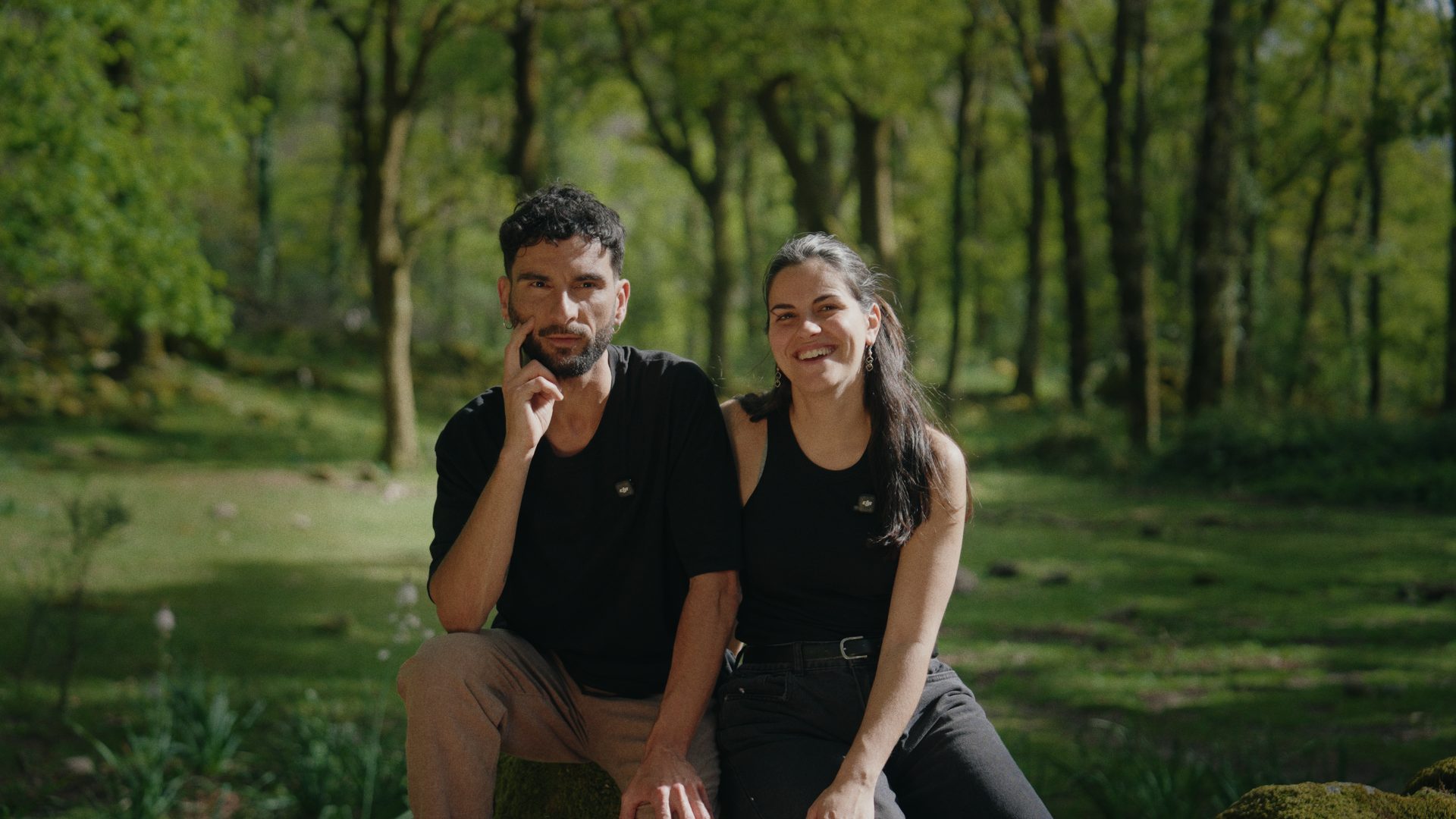 Diana and João in a sunlit forest in Minho