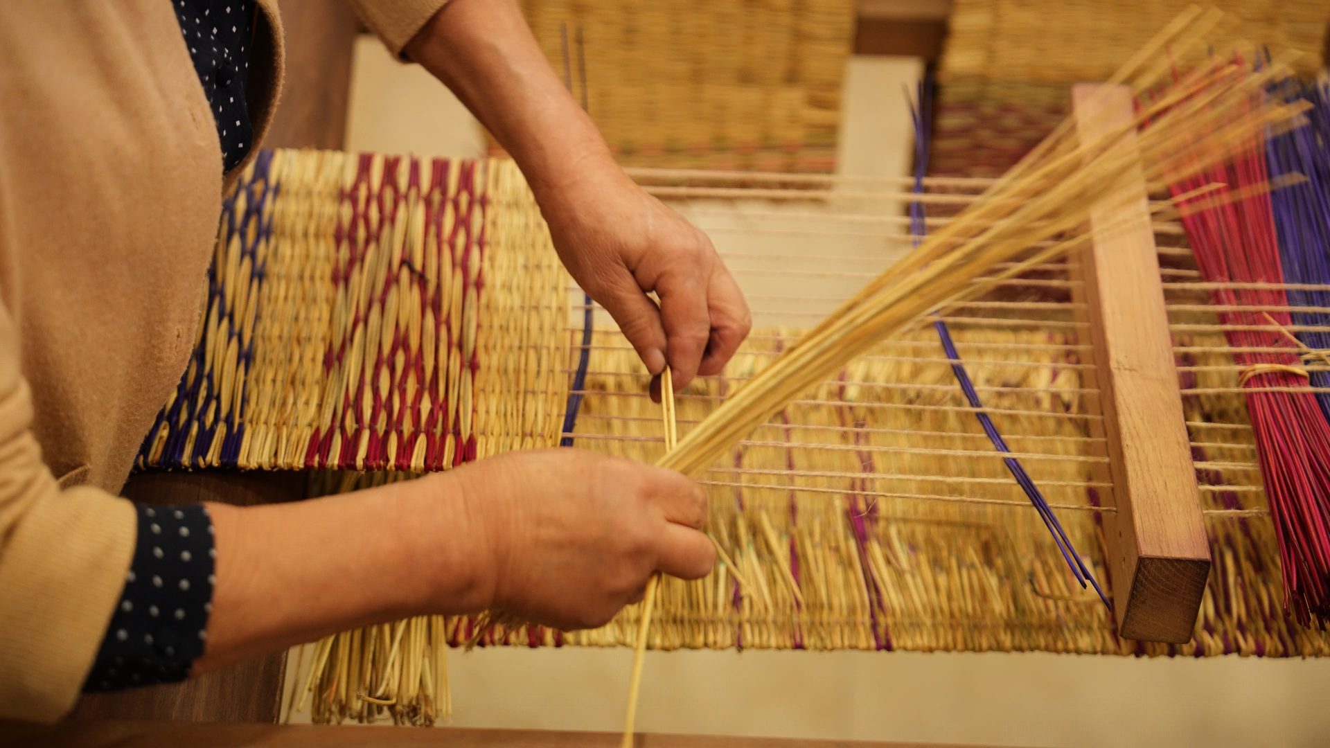 Hands weaving on a traditional loom in Minho