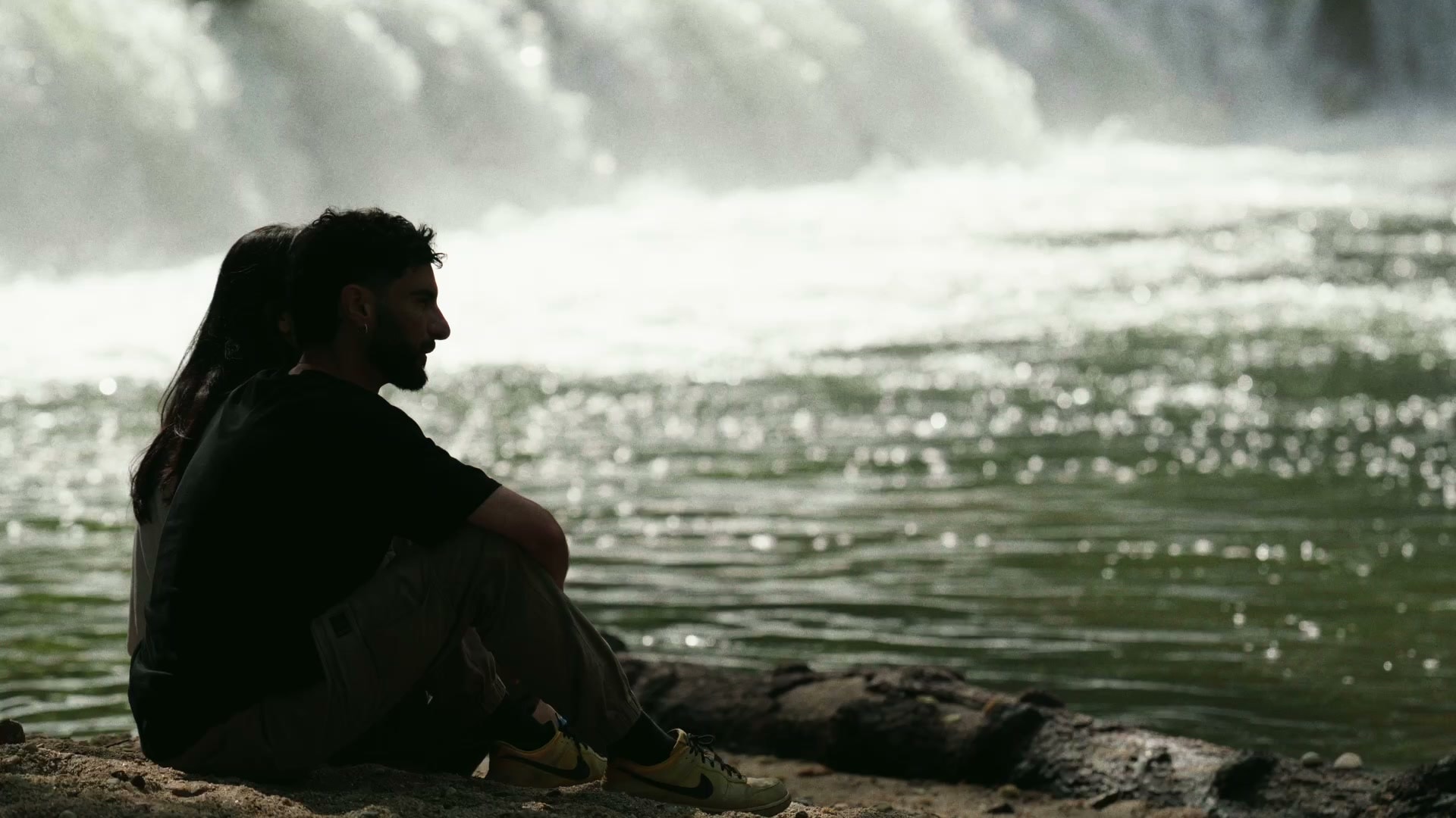 Diana and João sitting beside a river in Minho